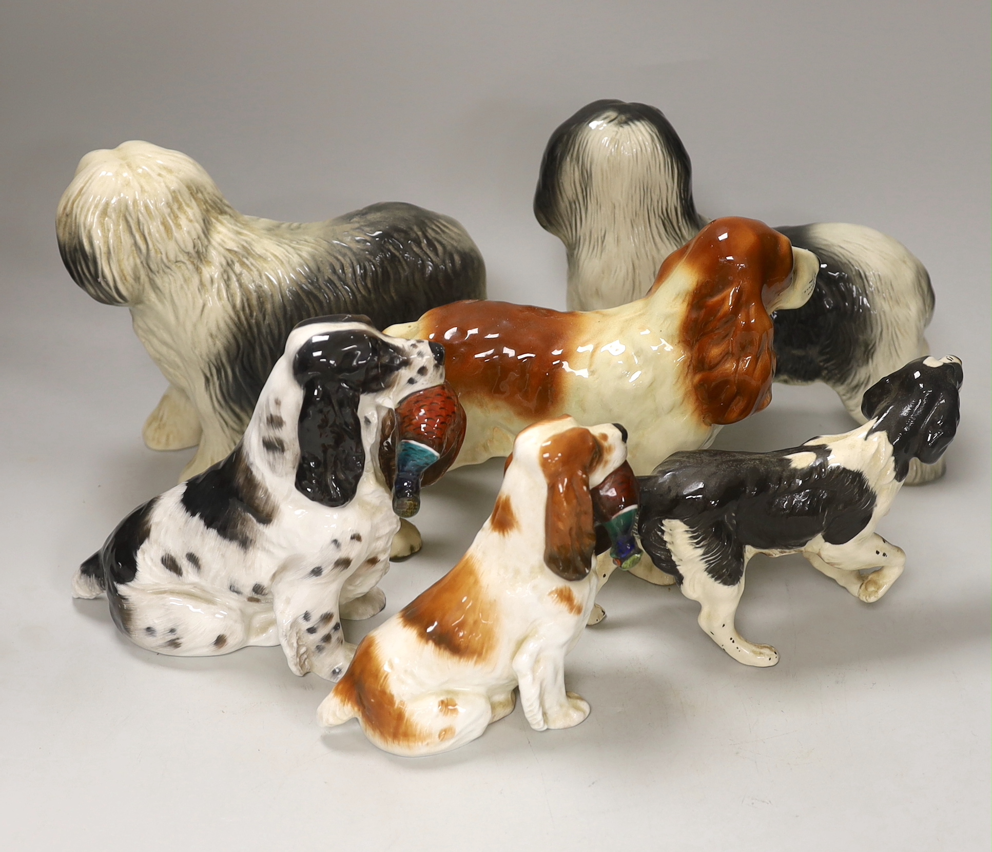 A group of six ceramic models of dogs including Royal Doulton and Beswick